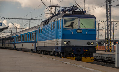 Fototapeta na wymiar Blue electric engine with fast train to Prague arriving from Pilsen main station