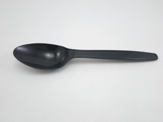 Black plastic disposable spoon for eating