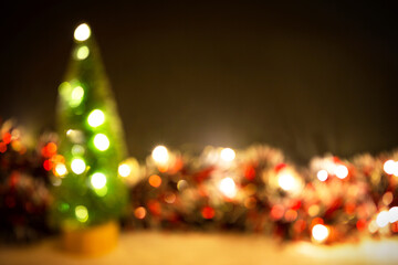 Christmas background with blur Golden lights of garlands in the bokeh. Red tinsel, Christmas tree. New Year. Copy space.
