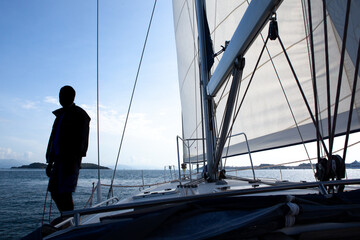 silhouette of a man on a sailing yacht. concept of active recreation and travel