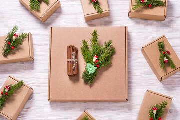 Set of brown cardboard boxes decorated with christmas tree ornament on wooden background