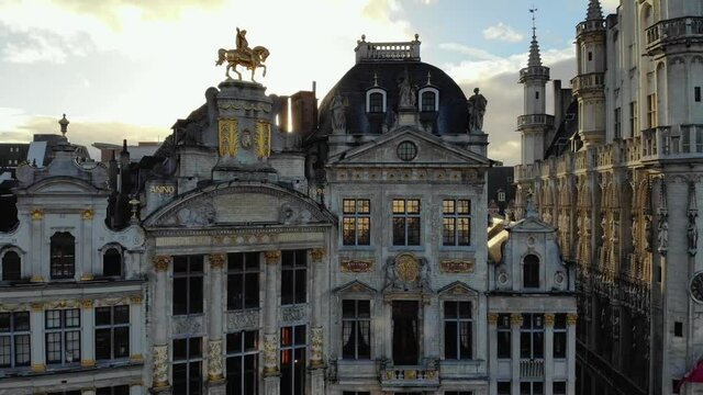 Aerial forward flying from Grand Place to Belgian beer museum Brussels square buildings on sunny and cloudy day of January, Belgium
