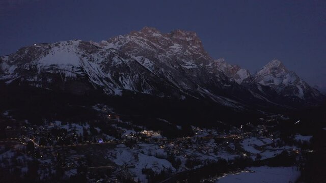Aerial 4K Drone Night View of Cortina d'Ampezzo in the Dolomites, including Monte Antelao and Monte Cristallo on a crisp cold spring night