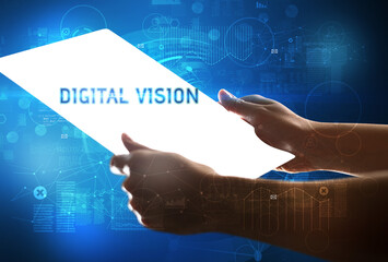 Hand holdig futuristic tablet with DIGITAL VISION inscription, new technology concept