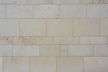 texture of a tiled beige stone wall as background