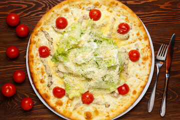 Pizza with chicken, cheese, herbs and tomatoes 