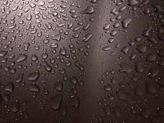 Rain water drop on shiny wax car surface