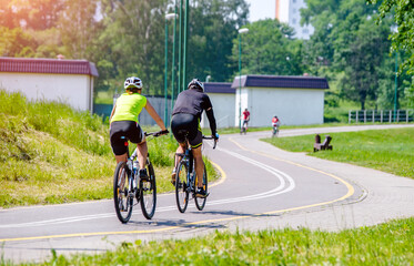 Cyclists ride on the bike path in the city Park
