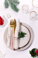 Winter festive table setting with cutlery on table. Christmas tableware.