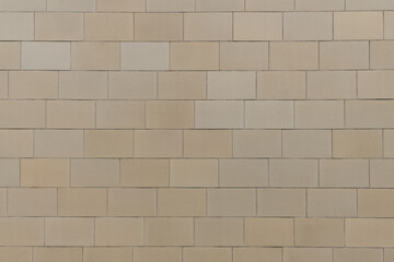 Fototapeta premium texture of a tiled beige stone wall as background