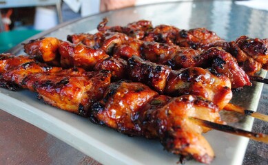 Juicy chicken slices barbequed in skewers