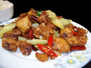Spicy fried chiciken bites with red hot peppers