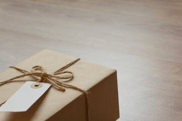 Tagged parcel on the table. Luggage, gift, parcel, delivery service, sending, receiving, etc.　テーブルの上の小包。荷物、贈り物、配達、送る、受け取る