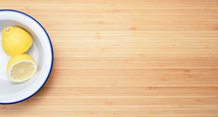 lemon on white plate and wooden background
