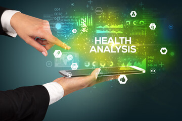 Close-up of a touchscreen with HEALTH ANALYSIS inscription, medical concept