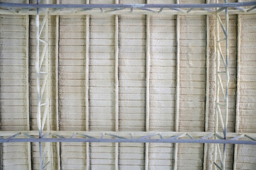 The roof of the building is coated with PU Foam. Construction site.