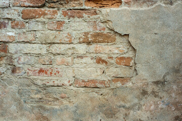 texture of an old damaged plastered brick wall as backdrop