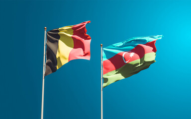 Beautiful national state flags of Azerbaijan and Belgium together at the sky background. 3D artwork concept.