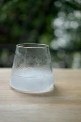 Glass with ice freeze on wood table
