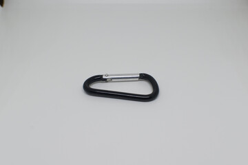 Black and silver aluminium carabiner on a white background