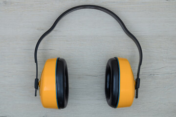 Construction, anti-noise headphones. Background with yellow headphones.