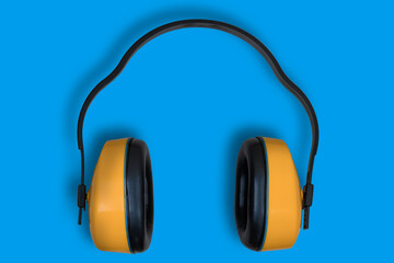 Construction, anti-noise headphones. Background with yellow headphones.
