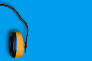 Construction, anti-noise headphones. Background with yellow headphones.