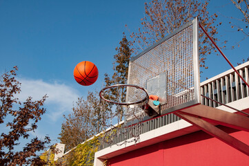 basketball orange ball flies to the hoop at the competition. High quality photo
