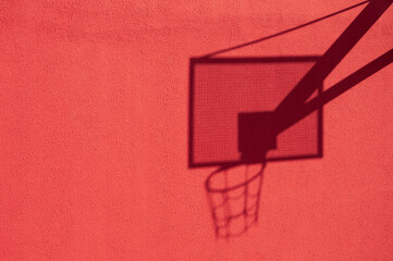 basketball hoop shadow on the red wall. High quality photo
