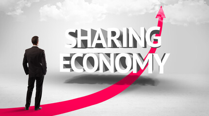 Rear view of a businessman standing in front of SHARING ECONOMY inscription, successful business concept