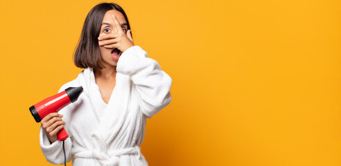 looking shocked, scared or terrified, covering face with hand and peeking between fingers