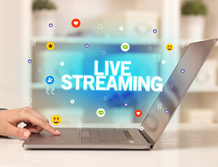 Freelance woman using laptop with LIVE STREAMING inscription, Social media concept