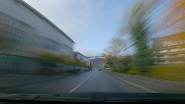 Sped up POV point of view dashcam dash camera driving around lake Bled, Slovenia. Motion blur effect. Famous landmark and tourist lake in Europe. Wide angle, forward dolly moving, real time