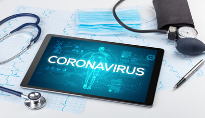 Tablet pc and doctor tools with CORONAVIRUS inscription, coronavirus concept