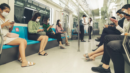 Crowd of people wearing face mask on a crowded public subway train travel . Coronavirus disease or...
