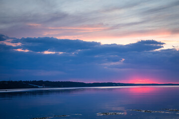 Sunset over the Kyiv Sea expressing contrast: beautiful sunset and polluted dirty water. Ecological concept