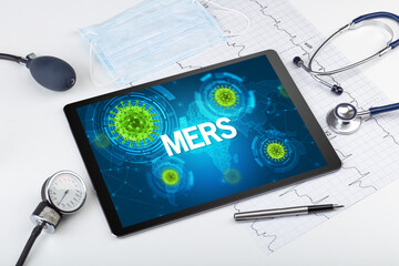 Close-up view of a tablet pc with MERS inscription, microbiology concept