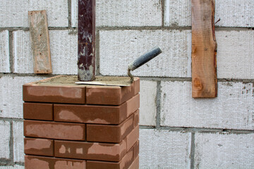 Construction of a brick fence using clinker bricks and cement with a columnar Foundation....