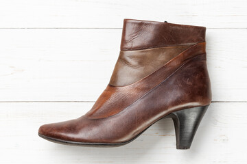 Women's autumn leather shoes on a white wooden table. Composition of clothes. Flatlay.