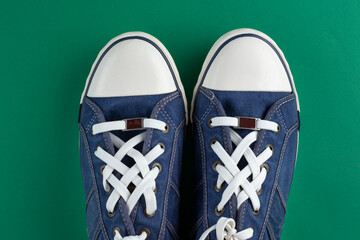 New blue gumshoes on green background