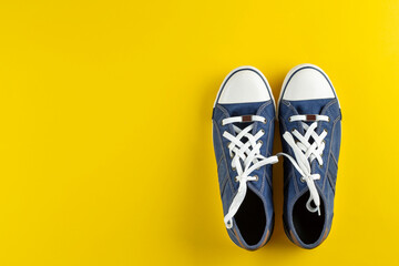 New blue gumshoes on yellow background