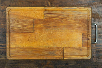 Rectangular cutting board on a wooden table. Space for text.