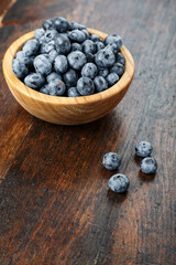 Fresh blueberries in a wooden bowl