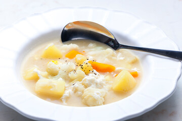 cauliflower soup with carrot, potato and egg