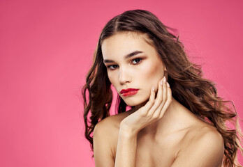 Sexy brunette model pink background red lips bared shoulders