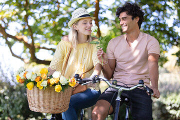 young couple riding on the bicycle