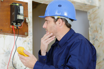 young electrician using a multimeter