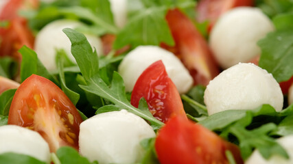 caprese salad with mini mozzarella, tomatoes cherry and arugula