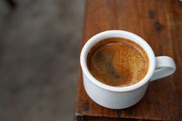 A cup of coffee on a wooden table             