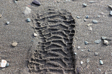 boot footprint on wet sand.